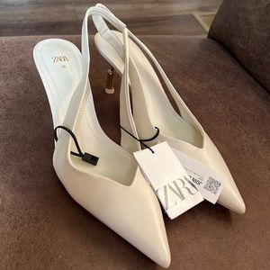 New with tags, white pointed toe sling backs. Never worn!